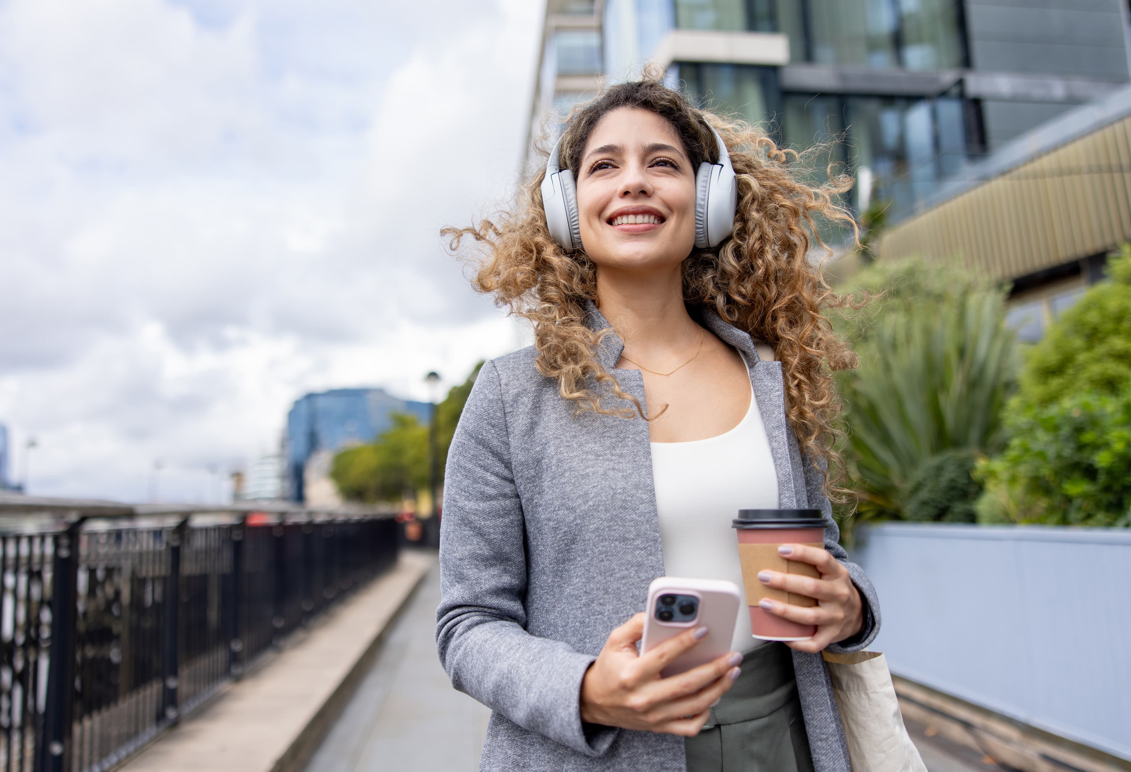 Woman listening to music with headphones outdoors